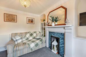 a living room with a fireplace and a couch at 2 Bed in Appledore oc-s29561 in Appledore