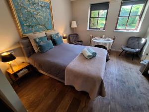 a bedroom with a bed and a table and chairs at Villa Sparadis in Spa +15 photos