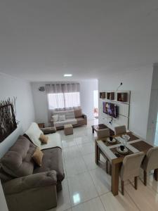 a living room with a couch and a table at Casa Marzenta in Petrolina
