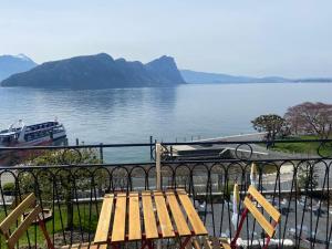 a wooden bench sitting next to a body of water at BnB Villa Kapellmatt - Seezugang, Bio-Frühstück, SUP am Rigi in Vitznau +26 photos
