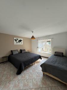 a bedroom with two beds and a window at Gîte Baytso in Auge +62 photos
