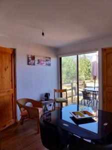 a living room with a table and chairs and a window at Cabañas El Oasis Laguna Verde in Laguna Verde