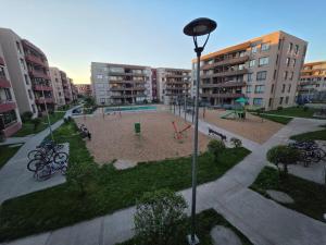 a park with a playground in a city with buildings at Comfort, Safety, and Connectivity in Chillán