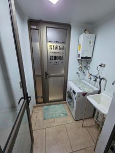 a laundry room with a washing machine and a sink at Comfort, Safety, and Connectivity in Chillán +2 photos
