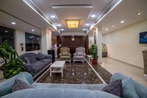 a lobby with couches and chairs and a tv at Orkeed Alolaya in Al Khobar