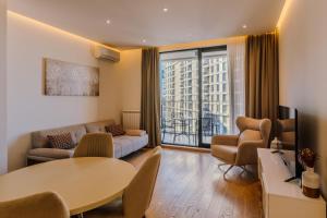 a living room with a couch and a table at Belgrade Waterfront Residences - Beograd na vodi in Belgrade