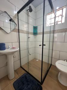 a bathroom with a shower and a sink at Pousada Taylor in Foz do Iguaçu
