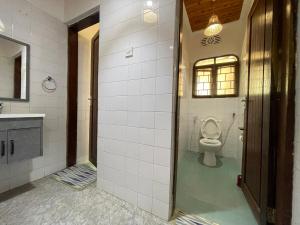 a bathroom with a toilet and a sink at Toiwo Residence Arusha in Arusha +10 photos