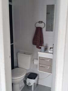 a white bathroom with a toilet and a sink at Oásis Xangri-lá in Xangri-lá +22 photos