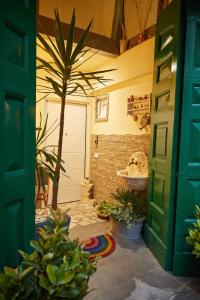 an open door of a garage with a palm tree at Dimora Daliah&Oana in Matera +45 photos