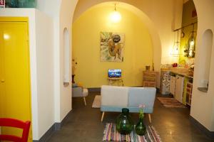 a living room with yellow walls and a blue couch at Dimora Daliah&Oana in Matera
