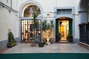 a store front with potted plants in front of a door at Dimora Daliah&Oana in Matera