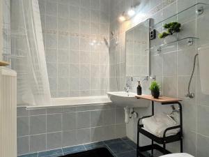 a bathroom with a sink and a shower and a toilet at Home4You Szombathely in Szombathely