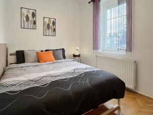 a bedroom with a bed and a window at Home4You Szombathely in Szombathely