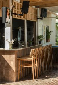a row of chairs sitting at a bar at Contessa Hotel in Argassi +104 photos