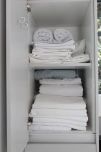 a stack of white towels in a closet at Tash's Place in Roodepoort +29 photos