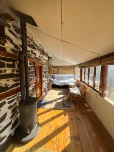 a living room with a woodburning stove in a house at The Himalayan Home in Nagar