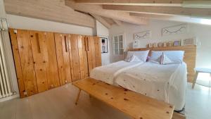 a bedroom with a bed and a bench in it at Casa Lilla in Gravedona +34 photos