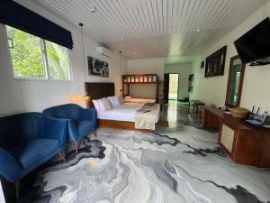 a bedroom with a bed and a large rug at River Splendour Home Stay in Ella