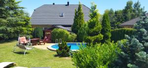 a house with a swimming pool in the yard at VILA CALLUM - výhodné dlouhodobé pronájmy v RD in Ostrava +4 photos