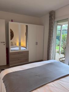 a bedroom with a bed and a large window at Appartement à Cala Rossa in Lecci