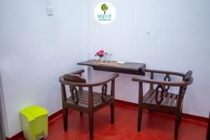 a table and two chairs with a table and a table and a stool at Breeze Heavens Yala in Polgahawelana +20 photos