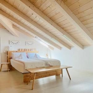 a bedroom with a bed and a wooden table at Casa Lilla in Gravedona