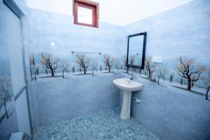 a bathroom with a toilet and a sink at Breeze Heavens Yala in Polgahawelana