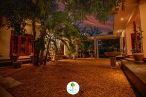 a room with a bunch of potted plants and trees at Breeze Heavens Yala in Polgahawelana
