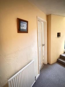 a room with stairs and a television on the wall at Mordor Lodge in Braunton