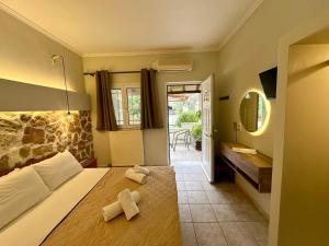 a bedroom with a bed with two crosses on it at Alkionis Garden View Apartments in Lefkada +45 photos
