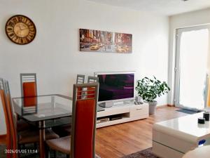 a living room with a television and a table at Ferienwohnungen Ferienhaus Nähe Winterberg Upland in Bromskirchen