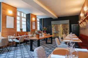a restaurant with tables and chairs in a room at Maison Soyeuse in Briançon