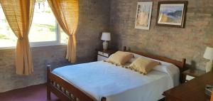 a bedroom with a bed and a window at Casa en Punta Colorada con gran fondo y fogón in Punta Colorada +12 photos