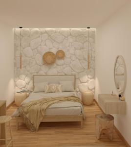 een slaapkamer met een bed met een stenen muur bij Aurora Suites, By IdealStay Experience in Amoudara Herakliou