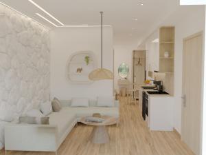 een witte woonkamer met een bank en een tafel bij Aurora Suites, By IdealStay Experience in Amoudara Herakliou