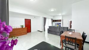 a living room with a table and a couch at Soulful Stay Phuket -Distant Seaview and Mountain View Retreat, Patong in Patong Beach