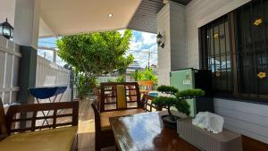 a balcony with a table and chairs on a house at Soulful Stay Phuket -Distant Seaview and Mountain View Retreat, Patong in Patong Beach