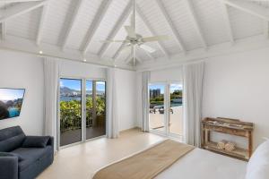 a living room with a ceiling fan and a couch at O SUN in Les Terres Basses