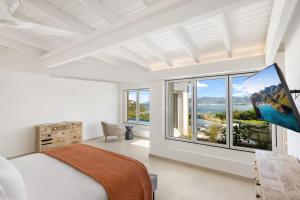a bedroom with a bed and a large window at O SUN in Les Terres Basses +39 photos
