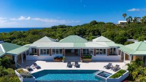 an aerial view of a house with a swimming pool at O SUN in Les Terres Basses