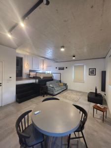 a living room with a table and chairs and a couch at Prime Fully Equipped Studio 4 Ideal Base to Explore Malta in Il-Furjana