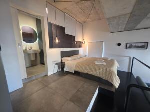 a small bedroom with a bed and a sink at Prime Fully Equipped Studio 4 Ideal Base to Explore Malta in Il-Furjana