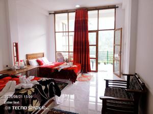 a bedroom with two beds and a large window at Hilltop Panorama Ohiya in Ohiya