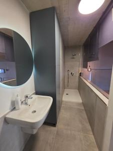 a bathroom with a sink and a shower at Prime Fully Equipped Studio 4 Ideal Base to Explore Malta in Il-Furjana +8 photos
