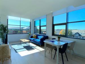 a living room with a table and a blue couch at Modern 2-Bed Apartment in Blu Bracknell in Bracknell