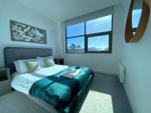 a bedroom with a bed and a window at Modern 2-Bed Apartment in Blu Bracknell in Bracknell