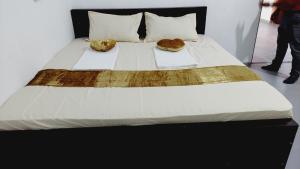a bed with two donuts sitting on top of it at Econest arugambay in Arugam Bay +17 photos