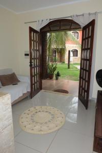 a room with a bed and an open door at Chalé em Condomínio com in Aracati