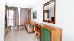 a living room with a table and a mirror at Las Faluas by Youroom in Playa del Ingles +13 photos